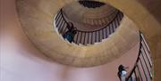 Two visitors on the staircase at Beckford's Tower