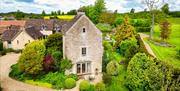 Dovecote Cottage's exterior surrounded by nature and forestry.