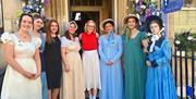 Jane Austen characters standing at the entrance of the museum