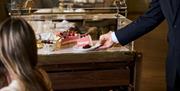 A dessert trolley laden with cakes at the Emberwood brasserie in Bath city centre