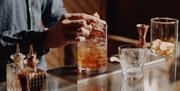 Person making a cocktail at No.15 by Guesthouse bar