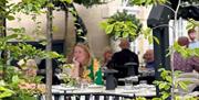 People sat in garden at hotel