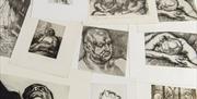 a selection of prints scattered on a table