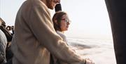 Couple in a balloon above the clouds