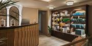 The reception at Francis Hotel Spa, with a large wooden cabinet of products to the right hand side.