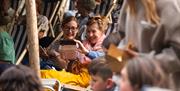 Two audience members smiling and taking a selfie at the Garden Theatre Festival in Bath.