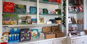 Shelves with goodies. Books, bears in pajamas, and sweets.