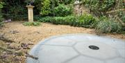 The stonework marking the spot where William Herschel discovered the planet Uranus in the garden at Herschel Museum of Astronomy, Bath