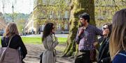 Jules talking to a tour in one of the squares or gardens in Bath