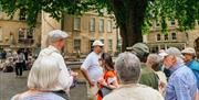 Tour guide and group taking a break in Bath