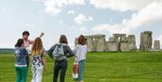 Jules presenting to his tour group in front of Stonehenge