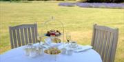 An afternoon tea on an alfresco table at Lucknam Park in Colerne, near Bath
