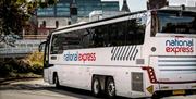 Bus parked and with a city backdrop