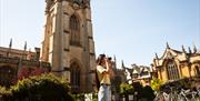 Women taking photo outside building