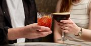 People holding cocktails
