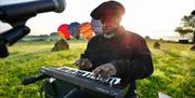 a man playing a keyboard in a field
