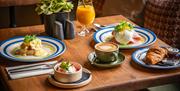 Breakfast options at Sydney's including tea, orange juice, and croissant