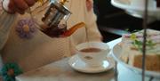 Person pouring tea