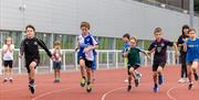 Children running on a track at Team Bath