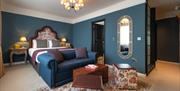 Large blue bedroom with patterned bedding at The Bear Inn
