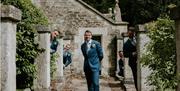 The groom and groomsmen hiding amongst the architecture