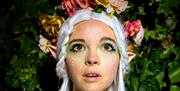 A beautiful elf among leaves