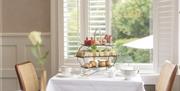 An afternoon tea on one of the interior tables at the Roseate Villa Bath's Henrietta Bar
