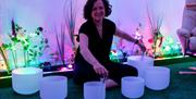 A woman leading a sound bath session at The Soul Spa in Bath.