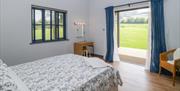 The bedroom of the Bluebell and an open walk-through to the countryside