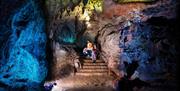 Family in illuminated cave at Wookey Hole Caves