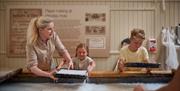 Children making paper at Wookey Hole - Caves near Bath and Bristol