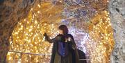 Wookey Witch looking at lights in caves