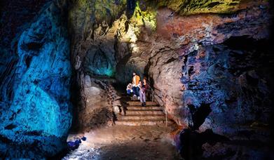 Family in illuminated cave at Wookey Hole Caves