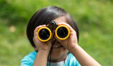 Boy looking through binoculars