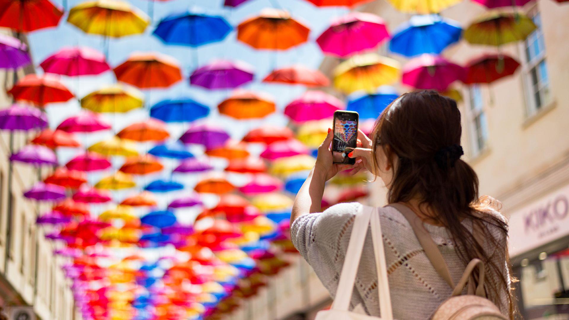 Person taking photo of umbrellas in SouthGate Bath