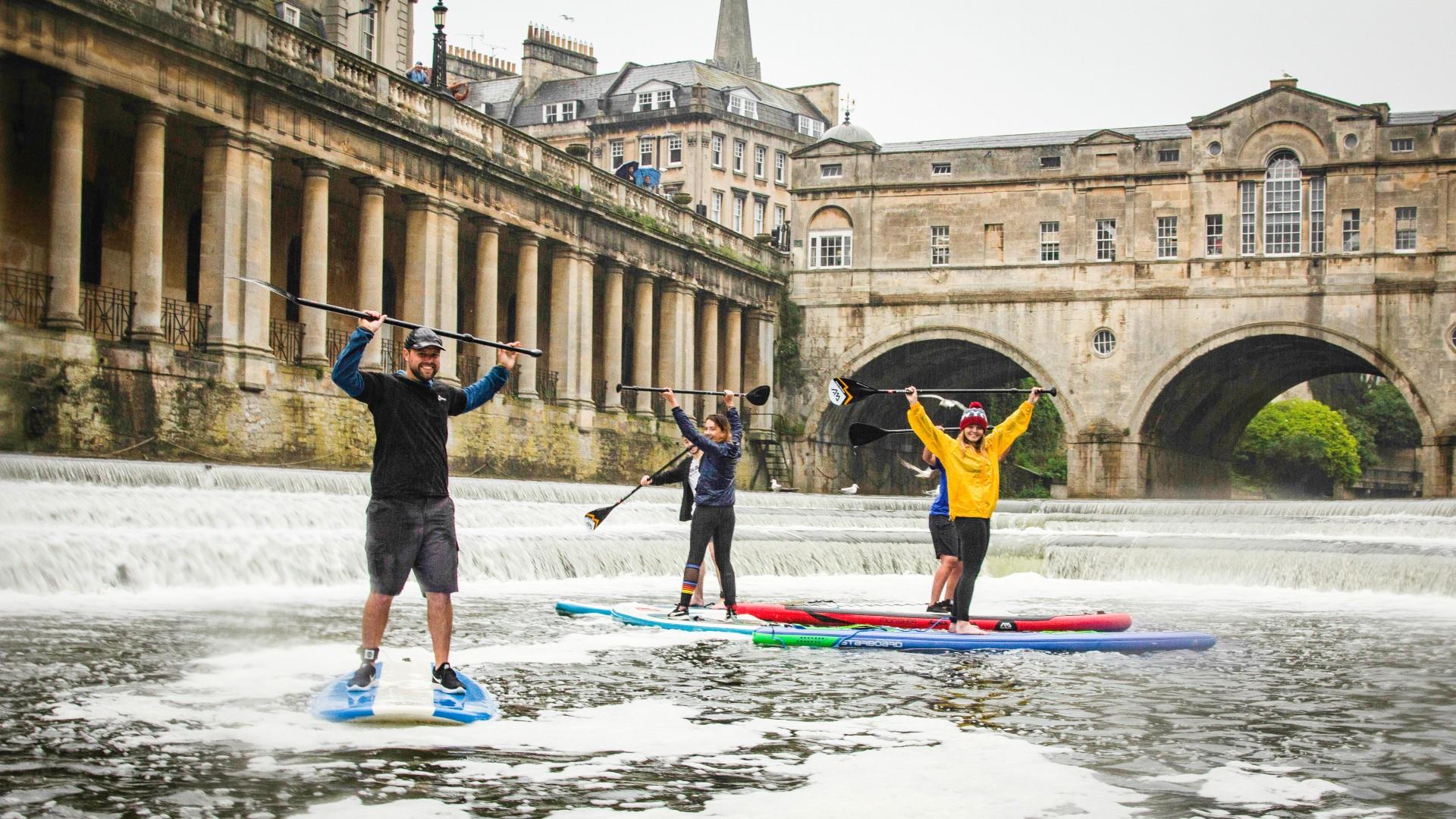 Stand up paddleboarders on Pulteney Weir