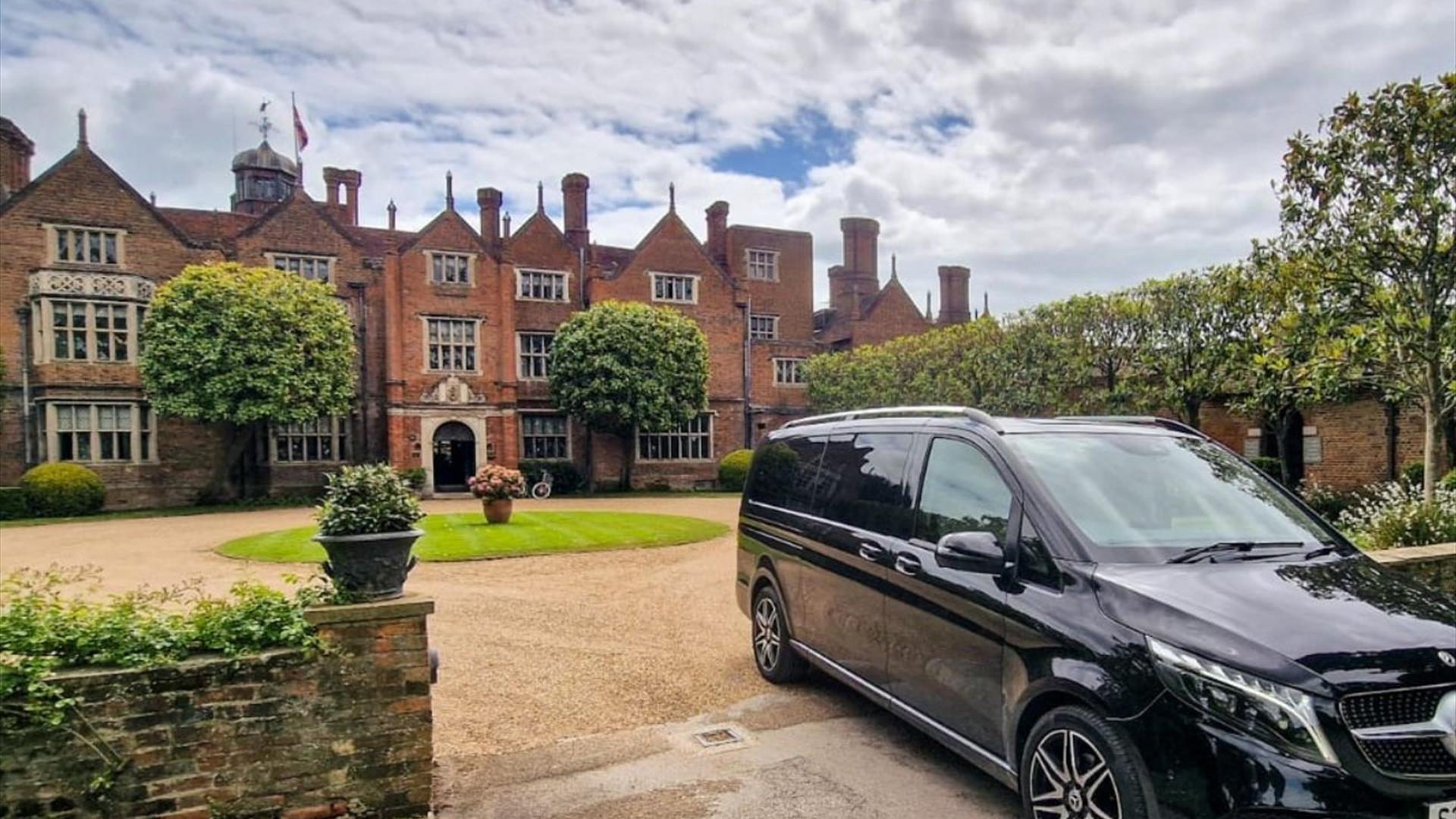 Minivan in front of manor house