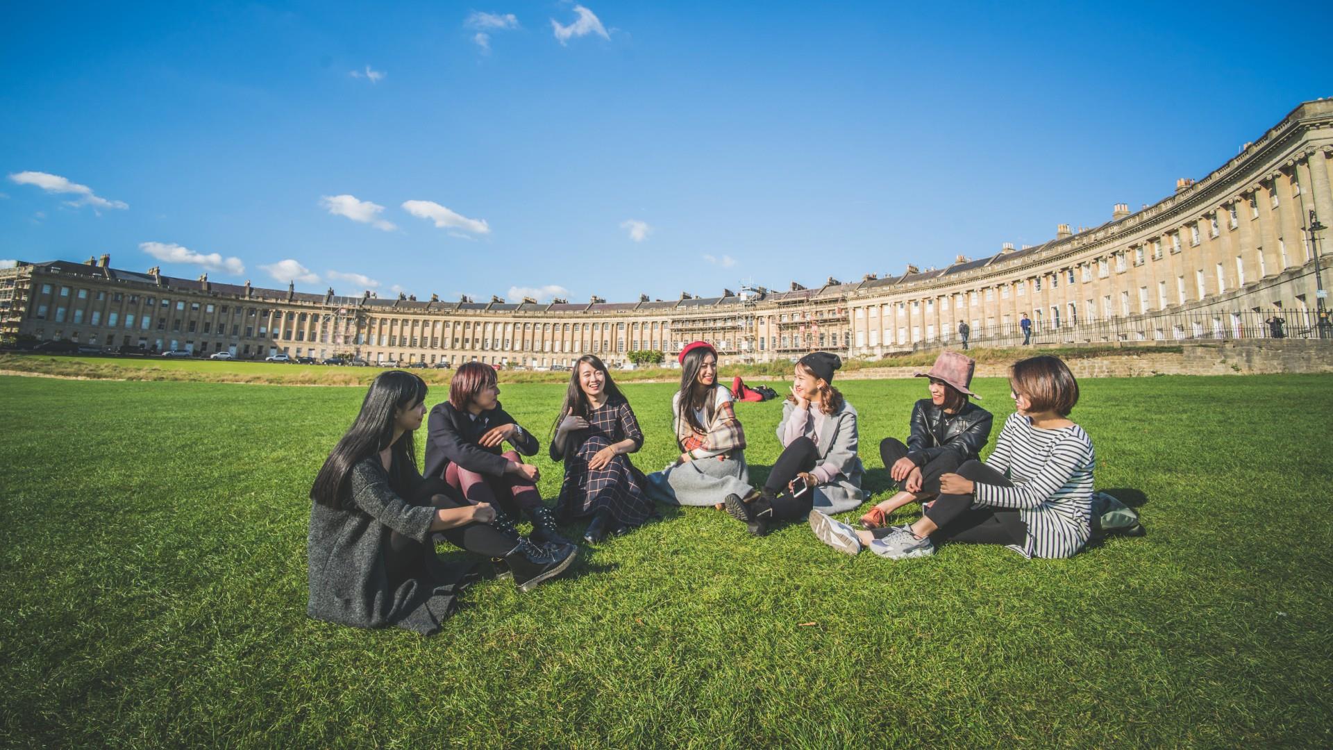 Group of students sit on Royal Crescent