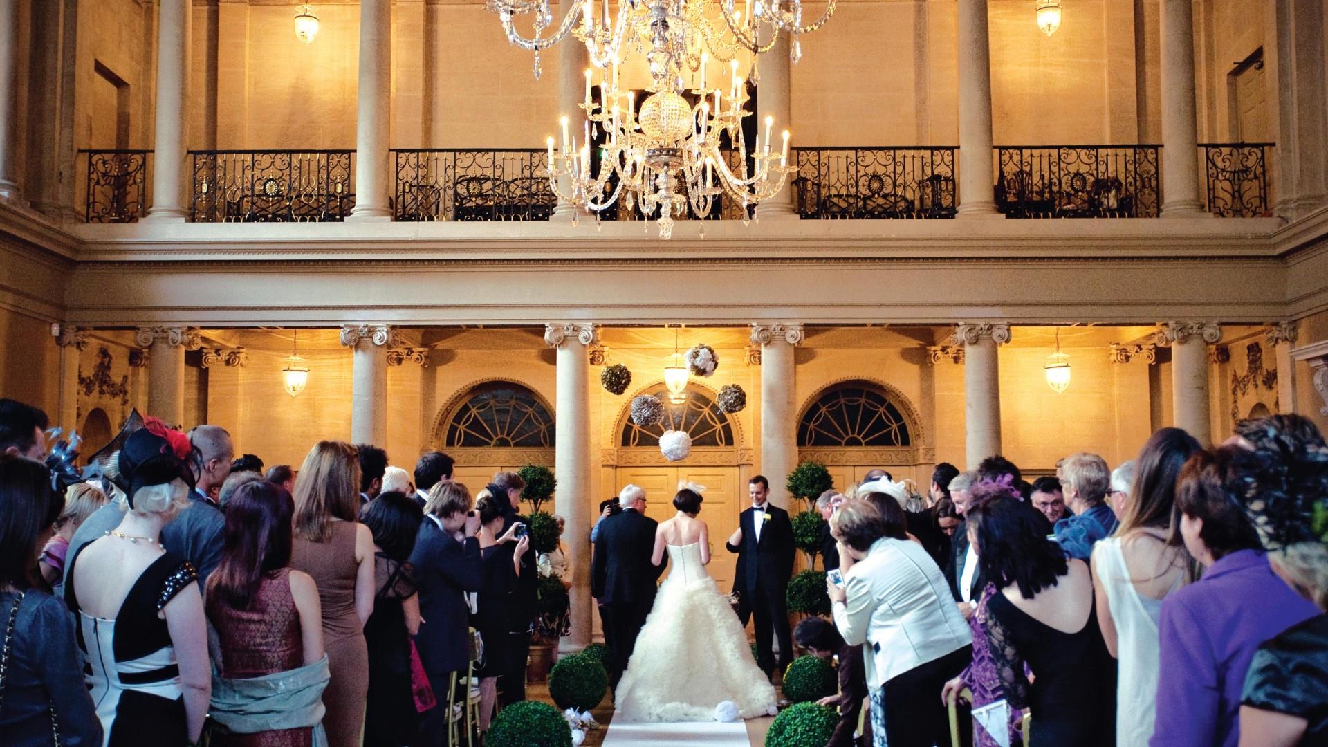 Bride and Groom stand at the end of the aisle