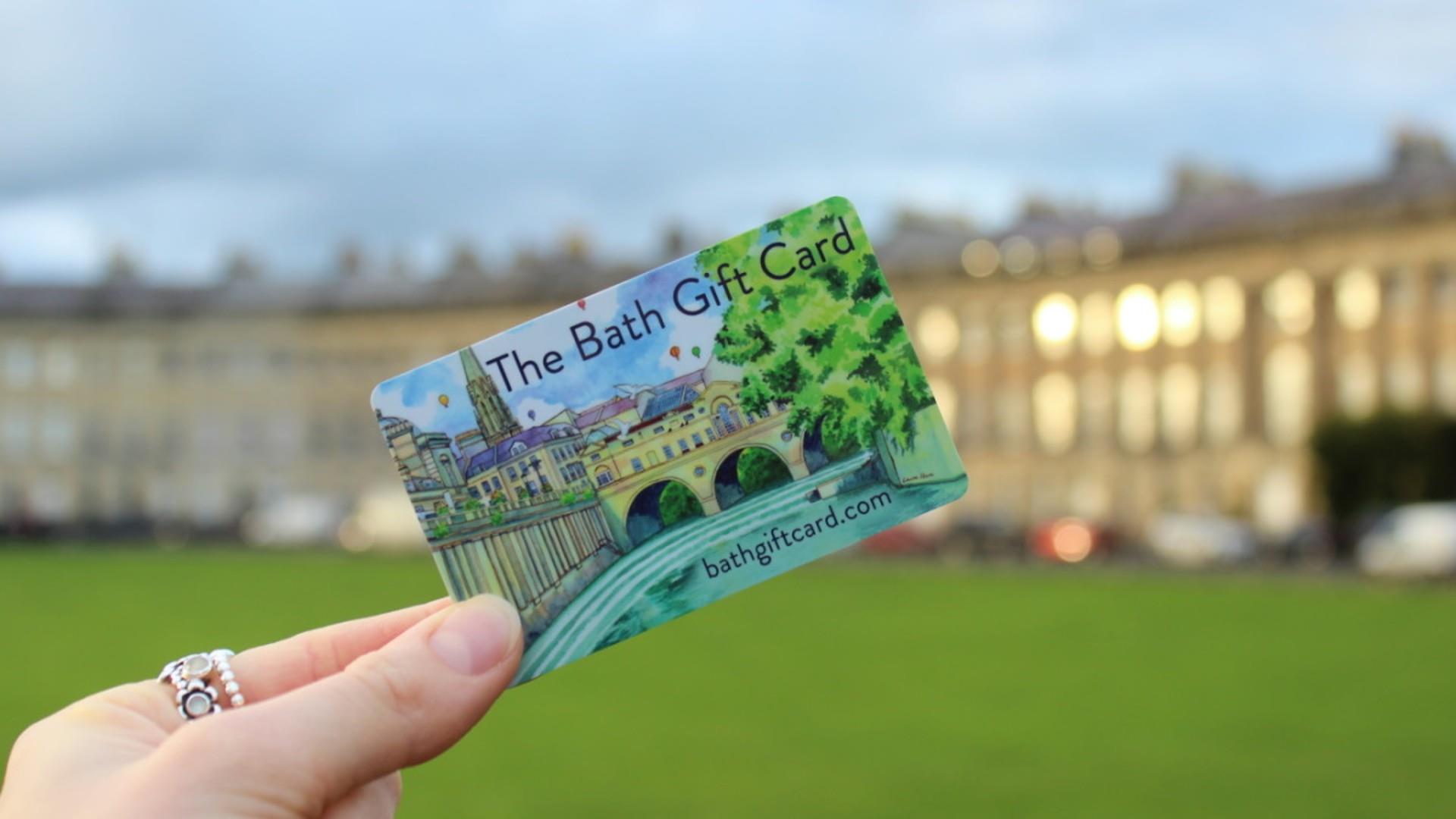 The Bath Gift Card held up in front of Royal Crescent