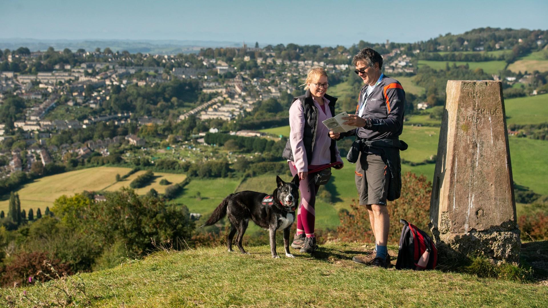 Dog walkers look at map whilst doing the Circuit of Bath Walk