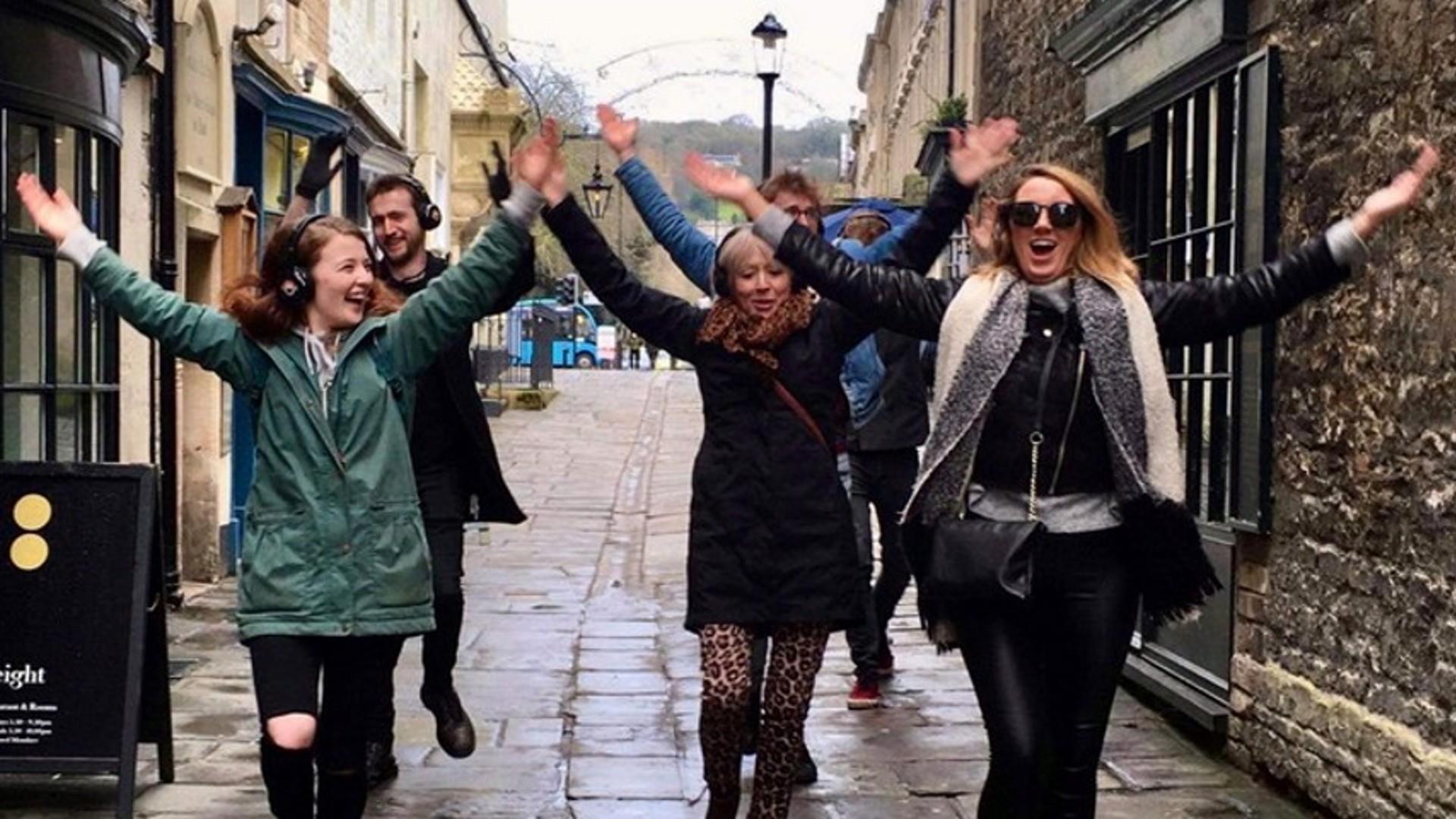 Group take tour around Bath wearing headphones