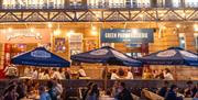 The exterior facade of Green Park Brasserie & Bath Pizza Co at night.