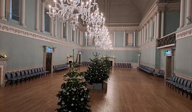 Christmas trees decorated under the chandeliers in the Ball Room.