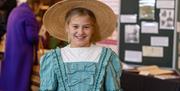 A young girl dressed up in period clothing at the World Heritage Day event in Bath's Guildhall