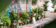 Decorated wedding table, colourful candles and flowers
