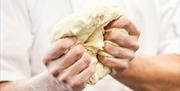 Hands with Pizza Dough