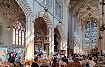 People sat in Bath Abbey listening to a music act