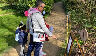 A family at Prior Park completing one of the Easter trail stations
