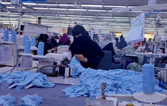 Photo of lady wearing a burka working in a textile factory